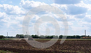 Rural everyday life. Combine rides and plows the field before planting crops. A tractor plows a field. Agriculture, farm and