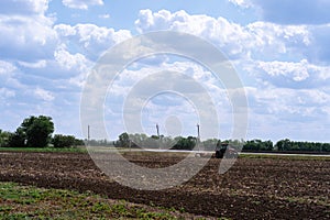 Rural everyday life. Combine rides and plows the field before planting crops. A tractor plows a field. Agriculture, farm and
