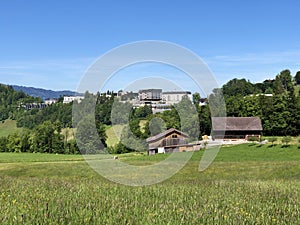 Rural farms and pastures on the slopes of the Mountain BÃ¼rgenstock Buergenstock or Burgenstock above Lake Luzerne