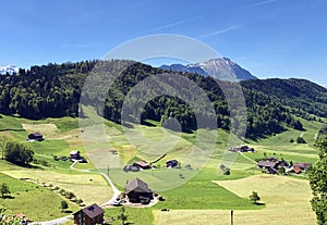 Rural farms and pastures on the slopes of the Mountain BÃ¼rgenstock Buergenstock or Burgenstock above Lake Luzerne