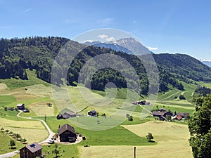 Rural farms and pastures on the slopes of the Mountain BÃ¼rgenstock Buergenstock or Burgenstock above Lake Luzerne