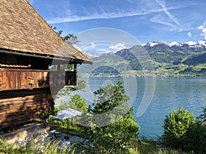 Rural farms and traditional architecture on the glades of the hills and the slopes of the mountains along Lake Luzerne