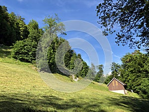 Rural farms and traditional architecture on the glades of the hills and the slopes of the mountains along Lake Luzerne