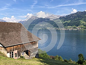 Rural farms and traditional architecture on the glades of the hills and the slopes of the mountains along Lake Luzerne