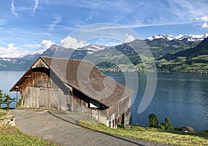 Rural farms and traditional architecture on the glades of the hills and the slopes of the mountains along Lake Luzerne