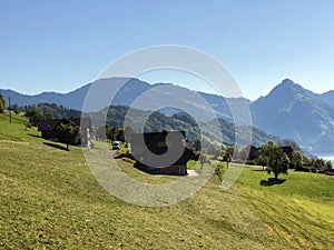 Rural farms and traditional architecture on the glades of the hills and the slopes of the mountains along Lake Luzerne