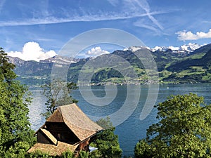 Rural farms and traditional architecture on the glades of the hills and the slopes of the mountains along Lake Luzerne