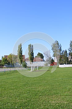 Rural football, soccer pitch taken from the grandstand on a sunny spring, summers day.