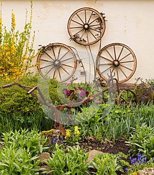 Rural garden decorated with cart wheels