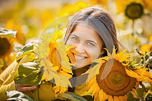 Rural girl in field sunflowers