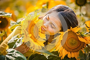 Rural girl in field sunflowers