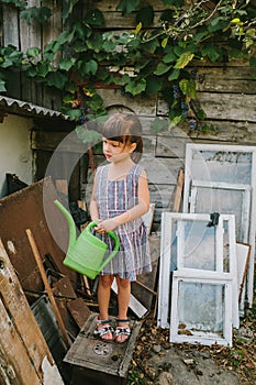 Rural girl among the old wooden trash