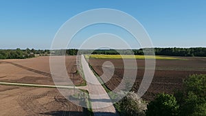 Rural gravel road in early spring, aerial view