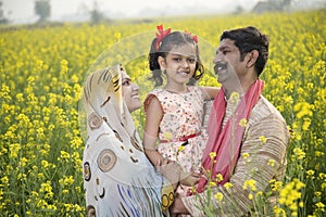 Rural happy Indian family in agricultural field