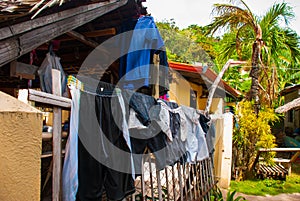 Rural house with many dried clothes in Apo island, Philippines