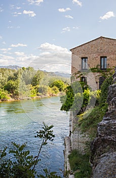 Rural house overhanging river photo