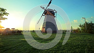 Rural house on village landscape. Panoramic view of country house and windmill