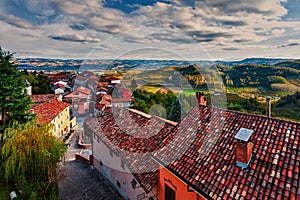 Rural houses and autumnal hills on background in Italy.