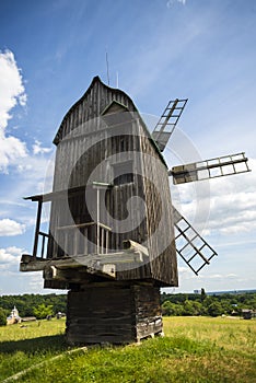 Rural idyllic landscape with wooden windmill