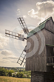 Rural idyllic landscape with wooden windmill