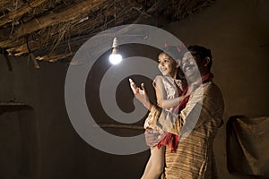 Rural Indian father with daughter delighted on electricity reaching their home