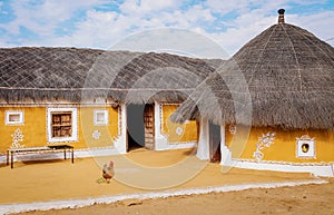 Rural Indian village with mud huts and thatched roof at Jaisalmer, Rajasthan, India