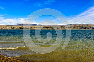 Rural lake landscape with reeds, wildlife and with blue skies and clouds