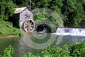 Rural landscape with abandoned watermill in forest