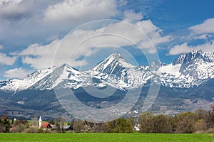 Rural landscape on a background of snow-capped mountains