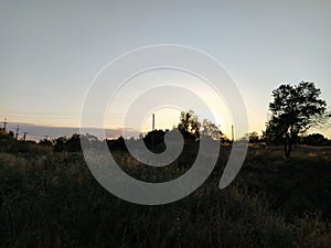 Rural landscape with church at sunset