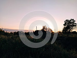 Rural landscape with church at sunset