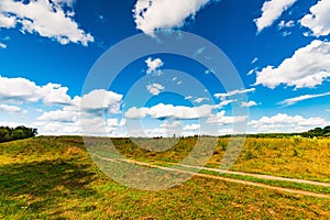 Rural landscape dirt road in the field