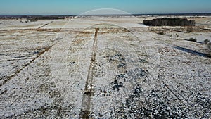 Rural landscape from drone, fields and meadows covered with snow in winter in Poland