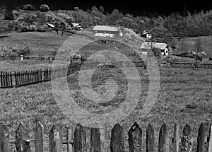 Rural landscape of fields separated by wood fences at spring in Maramures Romania.