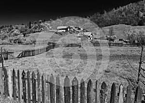 Rural landscape of fields separated by wood fences at spring in Maramures Romania.