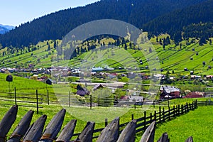 Rural landscape of fields separated by wood fences at spring in Maramures Romania.