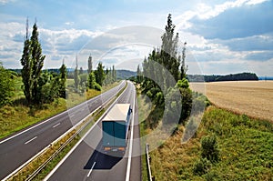 The rural landscape with a highway leading poplar alley