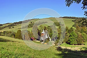 Rural landscape in Low Beskids Beskid Niski with wooden orthodox church in Chyrowa village, Poland