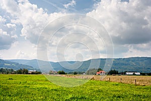 Rural landscape in Moravian-Silesian region against the background of mountains Western Carpathians