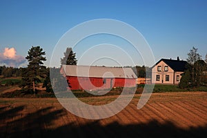 Rural landscape: old barn and two-story farm house