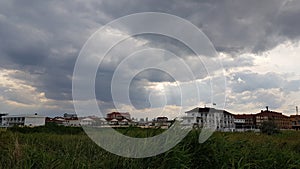 Rural landscape with overcast sky and sun rays shining