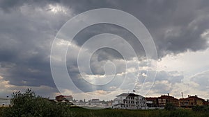 Rural landscape with overcast sky and sun rays shining