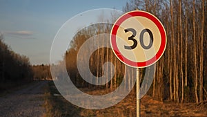 Rural landscape. Road sign at sunset against the backdrop of a spring forest