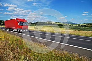 Rural landscape with road you are driving a red truck