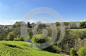 Rural landscape, with rolling hills and a distant church in, Cowling, UK