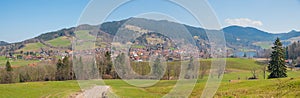 Rural landscape Schliersee area with view to spa town and green pasture, bavaria