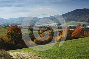 Rural landscape on a sunny day in autumn.Mountains in background.