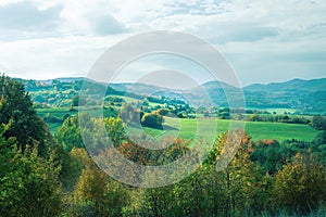 Rural landscape on a sunny day in autumn.Mountains in background.