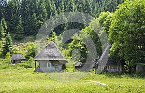 Rural landscape with traditional old wooden houses in Carpathian village. Ukrainian