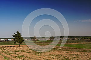 A rural landscape with a veil and a settlement in the background